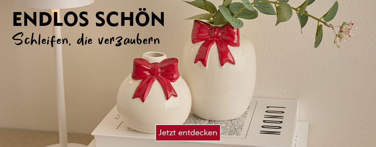 Wei&szlig;e Keramik Vasen mit roter Schleife verlinkt auf die Suche Schleifen