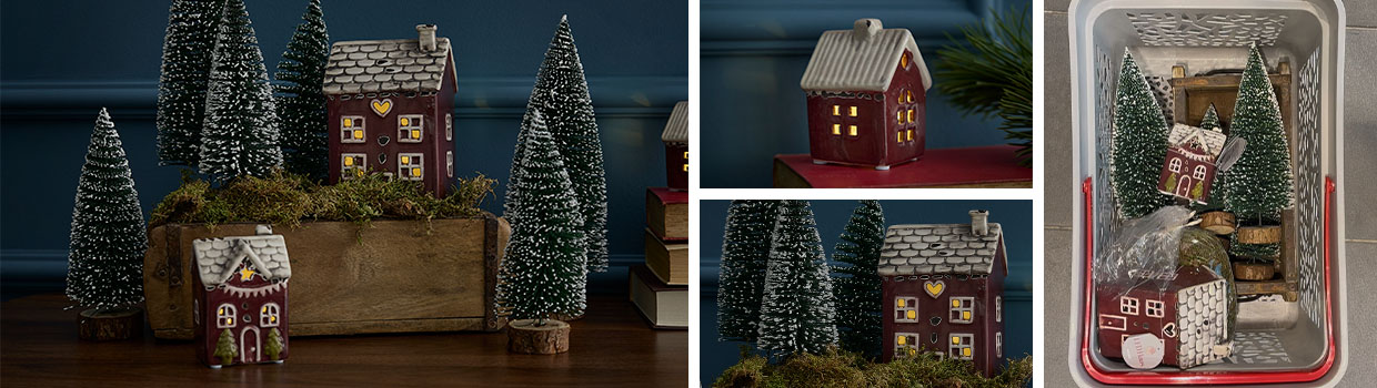 Ziegelform gefüllt mit Moos und LED-Haus mit Deko-Tannen wird präsentiert